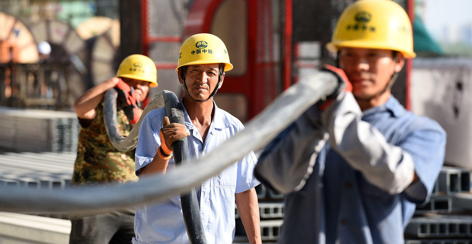 Chinese migrant workers of CREC labor at the construction site of the Huai'an East Railway Station for high-speed railway.