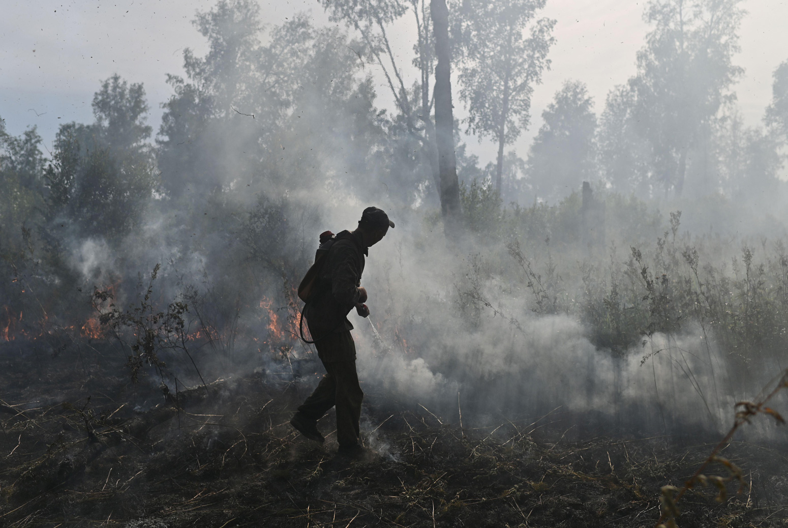 Russian Federal Agency for Forestry works to put out a forest fire in Basly, Russia in August 2020