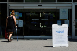 A woman enters a cooling centre during the scorching weather of a heatwave in Vancouver