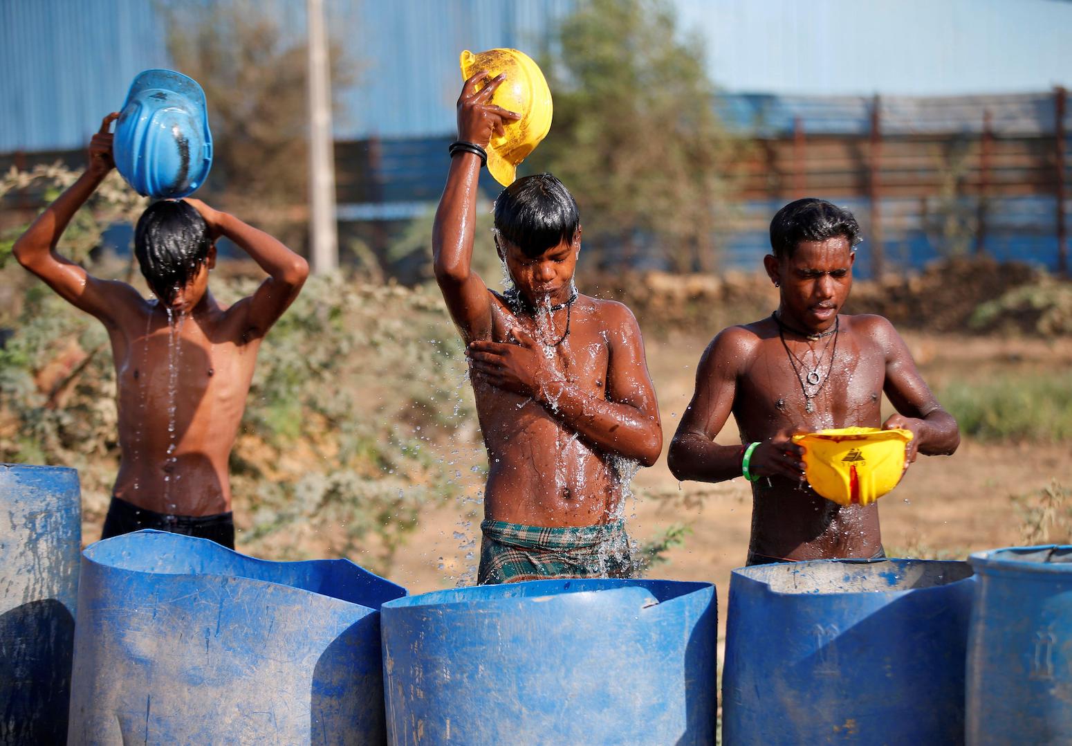 Construction workers cool themselves off during a heatwave in Ahmedabad, India