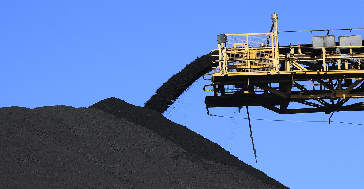 Conveyor belt empties coal into a pile