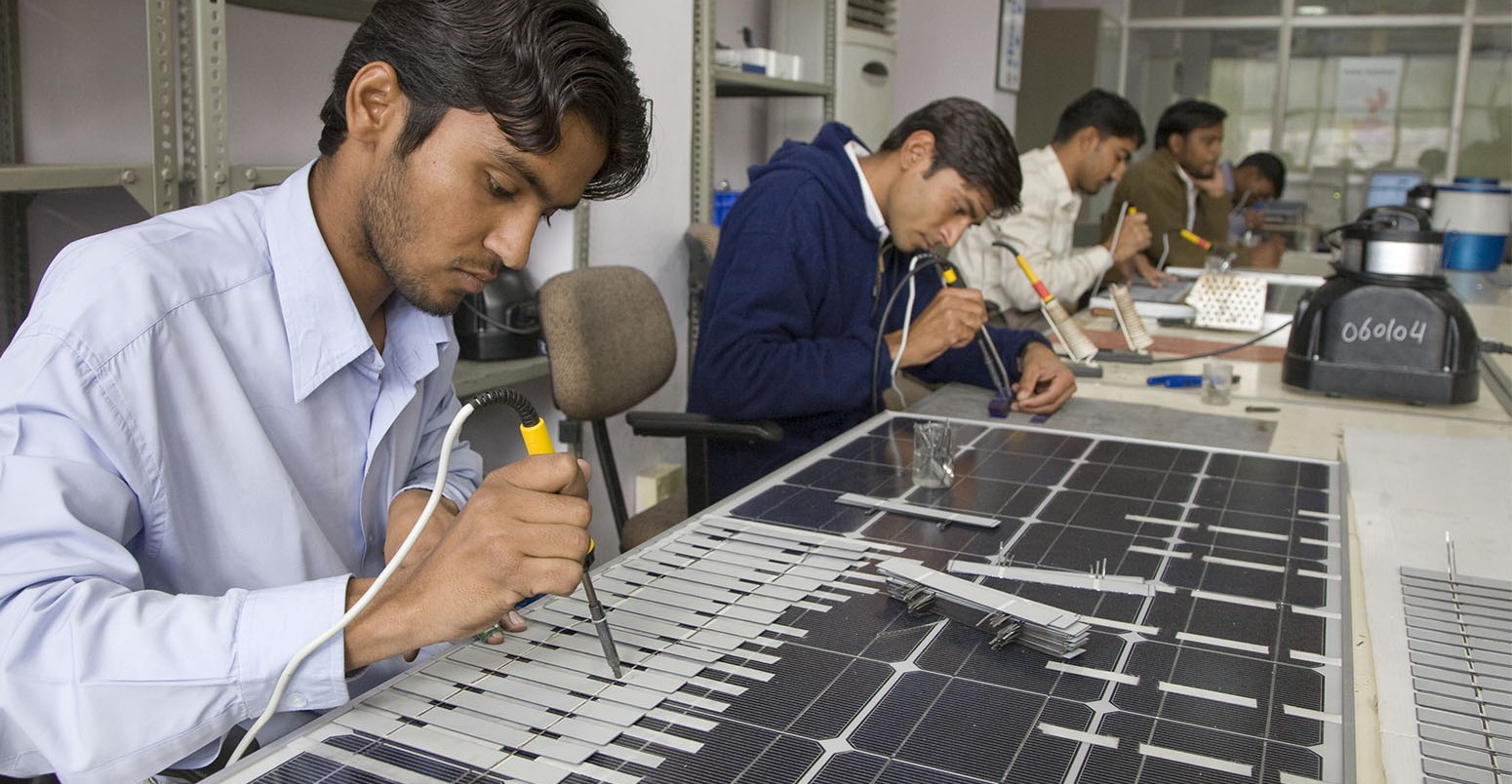 Solar panels being assembled in a factory near Jaipur, Rajasthan. The panels are for export to other countries and also for domestic use in India where solar power is helping to bring electricity to remote villages for the first time.