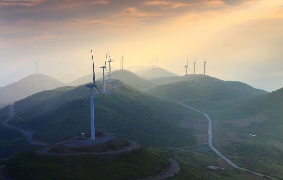 Wind turbines whirl to generate electricity at the Wangying Wind Farm in Lichuan city, central Chinas Hubei province