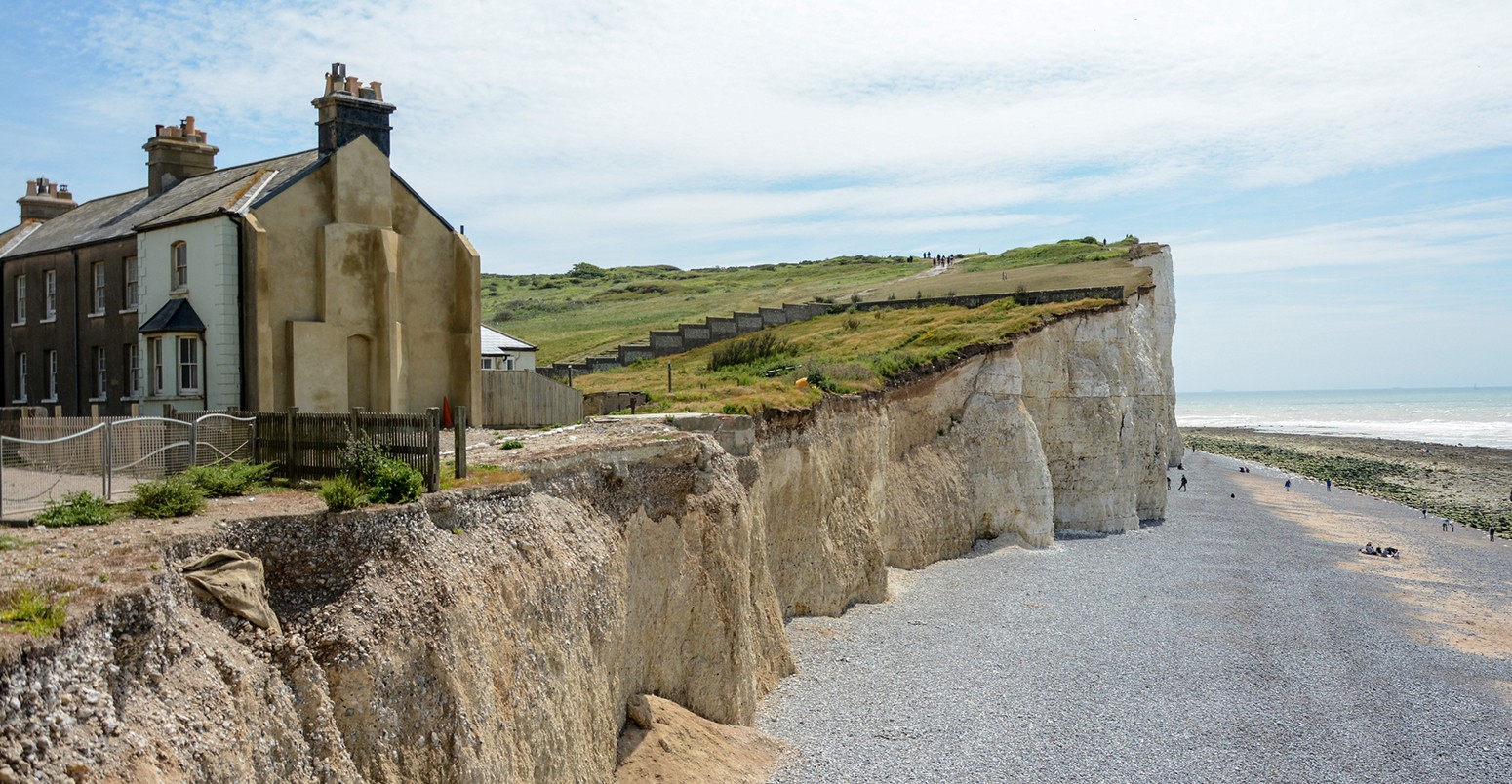 The cliffs being eroded at the Birling Gap. The houses on the cliff are long empty and uninhabited.