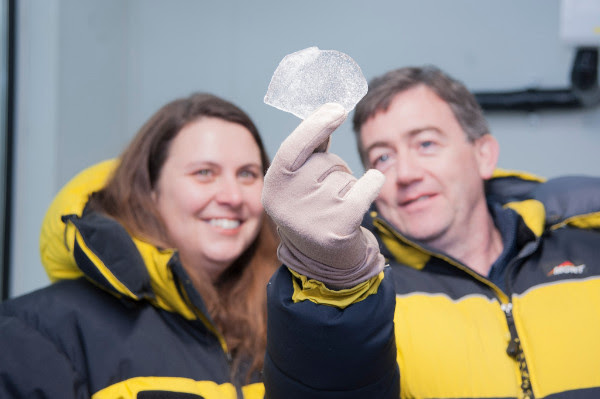 Mark Curran holds an ice core sample as Nerilie Abram looks on. Photo: Oliver Berlin