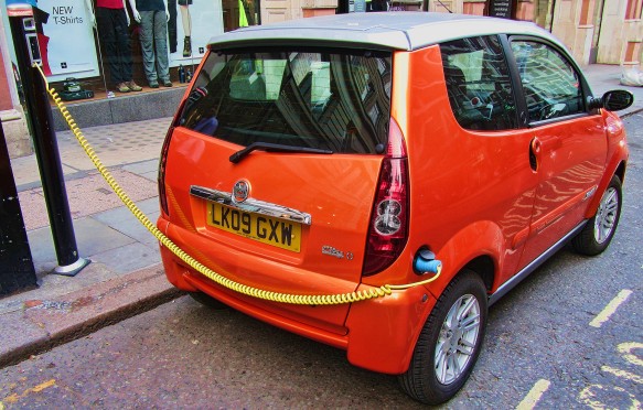 Orange electric car on charge, London, England, UK