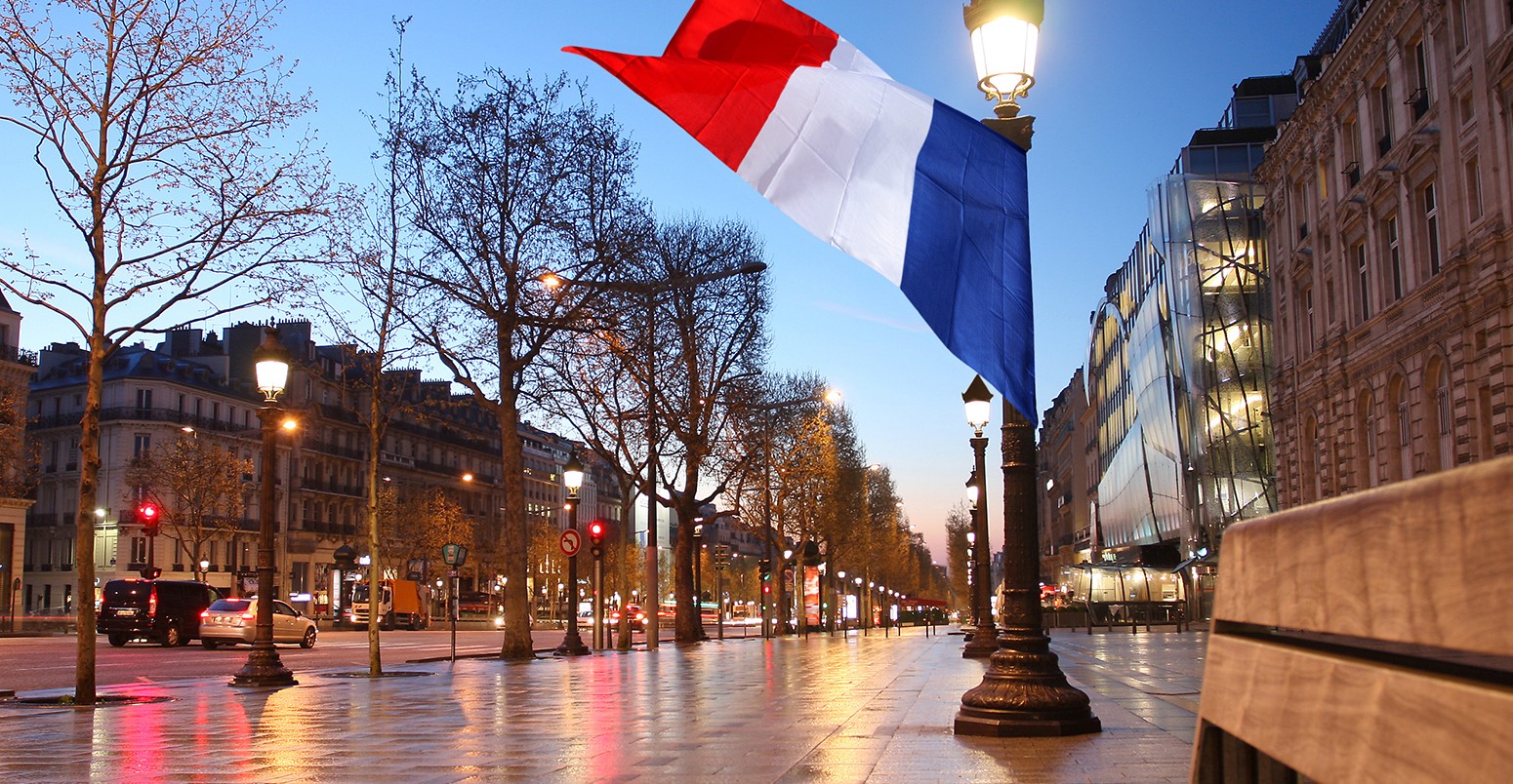 Flag flying in the Paris Champs Elysee street in the evening