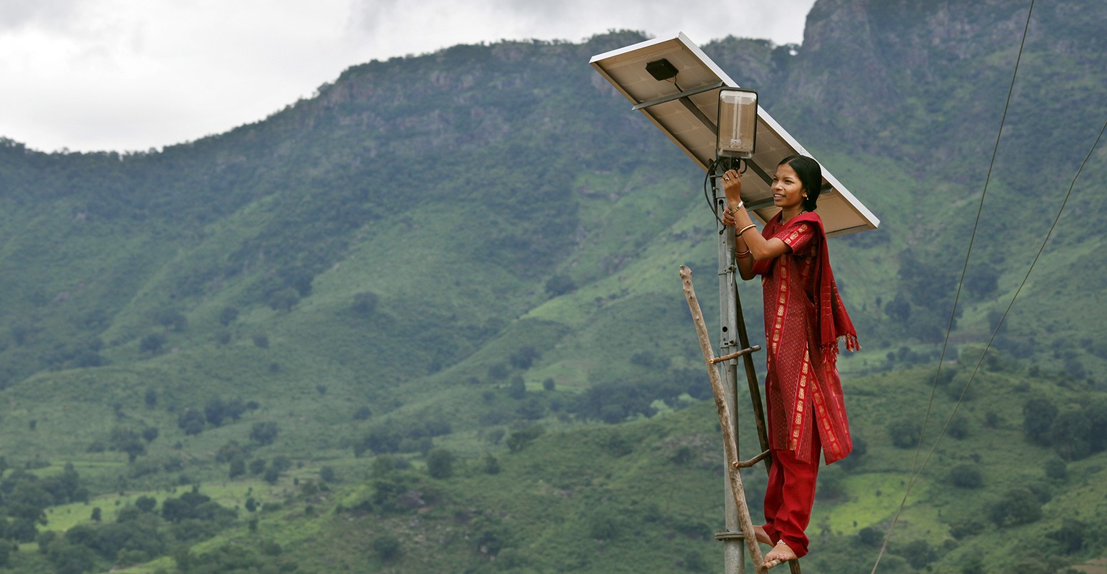Meenakshi Dewan tends to maintenance work on the solar street lighting in her village of Tinginaput, India.