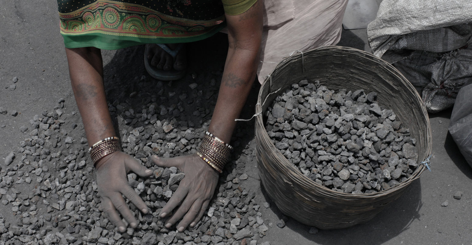 Women rummages through overburden to look for left over coal to sell at Jugsalai, India.