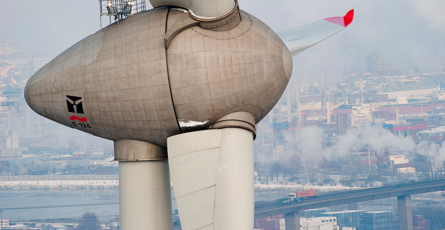 Enercon wind turbine E-126 with 6 MW in harbour and view on Hamburg City