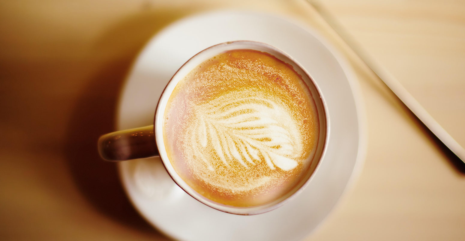 Latte coffee art. Vintage color effect, top view. Selective focus