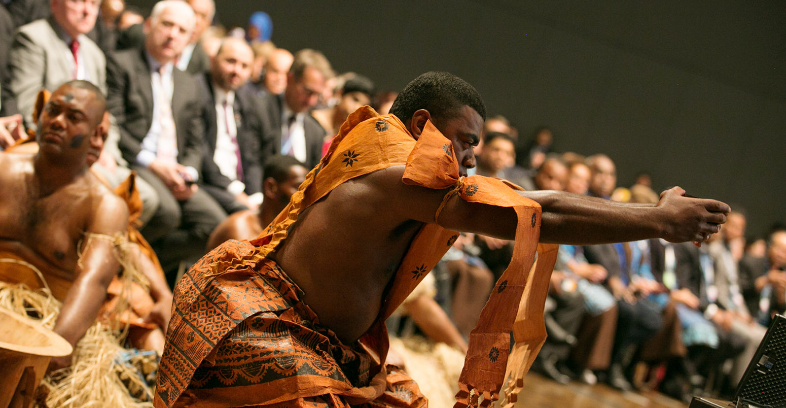 Representatives from Fiji perform a traditional ceremony, known as the Qaloqalovi, to open the meeting.