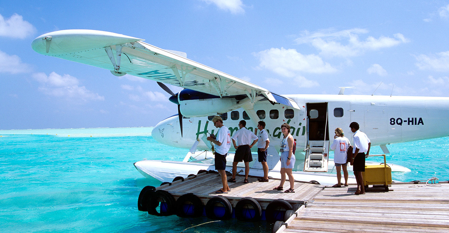 Passengers boarding a sea plane Maldives Indian Ocean. Credit: Sunpix Travel / Alamy Stock Photo. AKAWF0
