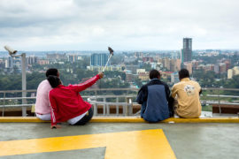 Teenagers taking a selfie looking out over the city in Nairobi, Kenya. Credit: Hugh Mitton / Alamy Stock Photo. G23XN7