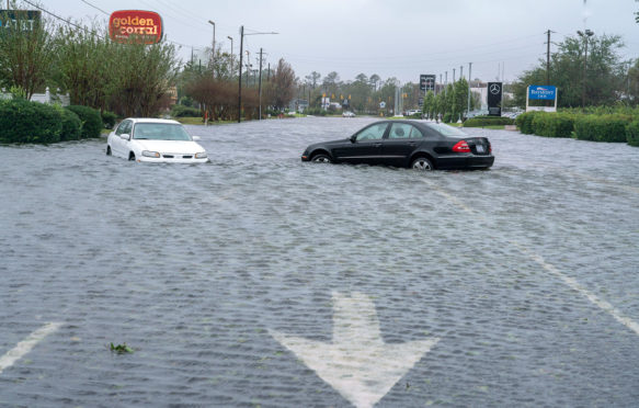 PKTMFJ Wilmington, United States. 15th Sep, 2018. Cars sit abandoned on a street during Hurricane, now tropical storm Florence September 15, 2018 in Wilmington, North Carolina. Tropical storm Florence is expected to drop more rain over the next few days and cause more flooding along North and South Carolina. Some rivers are expected to crest on Monday. Credit: Ken Cedeno/UPI Photo/Newscom/Alamy Live News