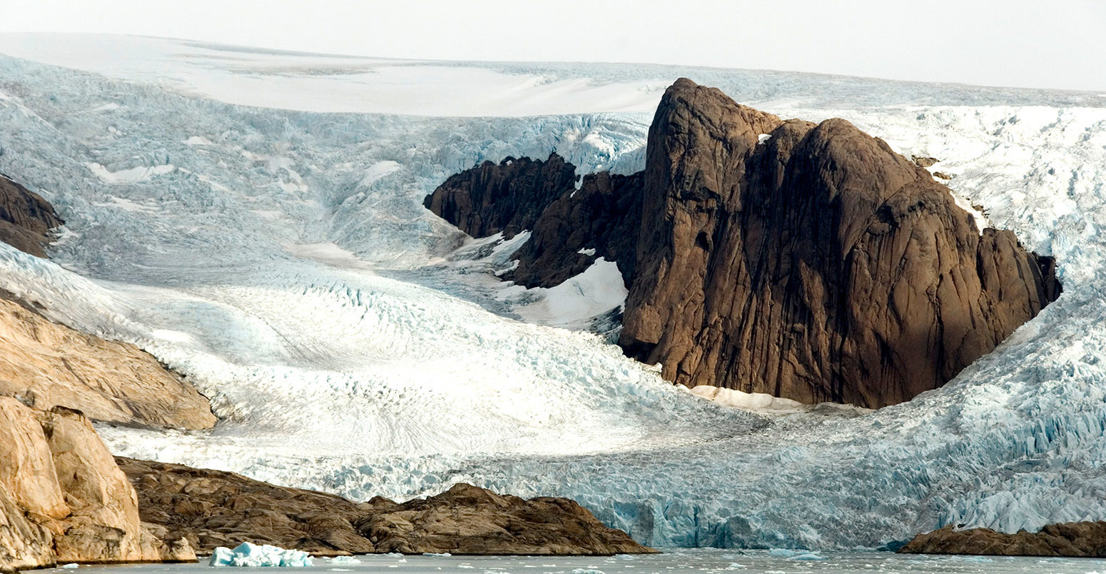 Outlet glaciers descending from main ice sheet, southern tip of Greenland. Credit: robertharding / Alamy Stock Photo. CFCT8J