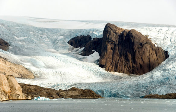 Outlet glaciers descending from main ice sheet, southern tip of Greenland. Credit: robertharding / Alamy Stock Photo. CFCT8J