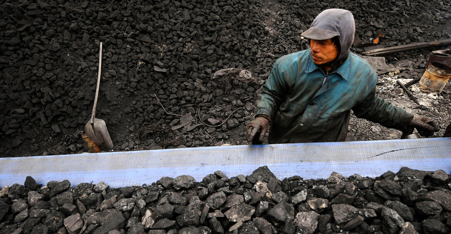Miners prepare coal for transport at a coal mine site in Changzhi, China. Credit: CPRESS PHOTO LIMITED / Alamy Stock Photo. EX2865