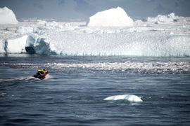 A boat transports people towards a glacier in Antarctica. Credit: Robert German / Alamy Stock Photo. M9B4XN