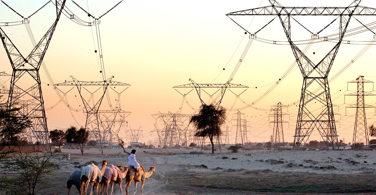 High voltage transmission lines in the desert, Dubai, United Arab Emirates. Credit: Agencja Fotograficzna Caro / Alamy Stock Photo. A6JFAW