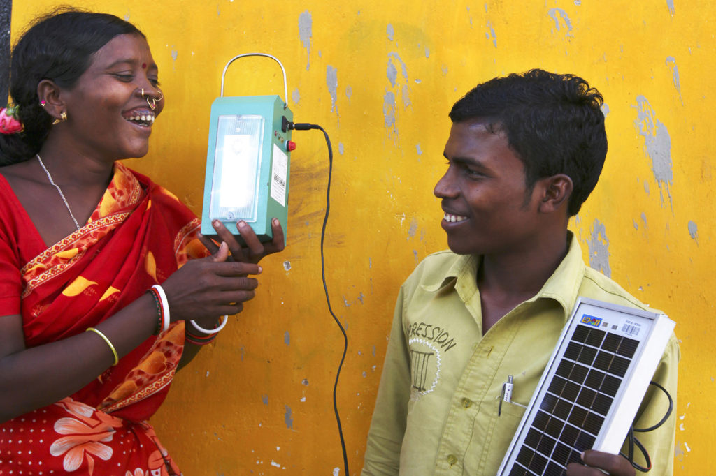 A “barefoot” solar engineer from Tinginaput, India, passes on her skills to other villagers teaching them how to make a solar lamp. Credit: Abbie Trayler-Smith / Panos Pictures / Department for International Development. (CC BY-NC-ND 2.0)