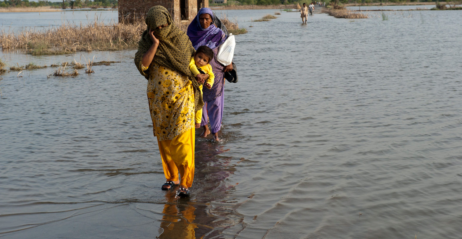 National Flood Emergency Response in Pakistan. A family crosses the flooded streets of Pakistan.