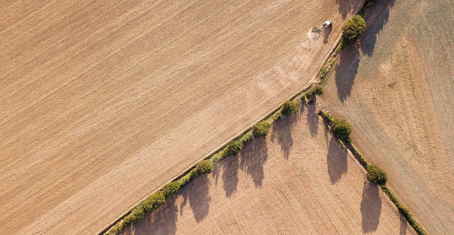 Aerial view of a tractor ploughing a field in Suffolk, UK. Credit: Chris Cullen / Alamy Stock Photo. 2A0X231