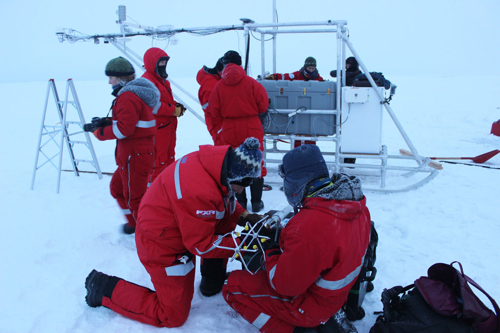 Dr Ola Perrson and a colleague attach a wind doppler to a scientific instrument in the Central Arctic Ocean. Credit: Daisy Dunne for Carbon Brief