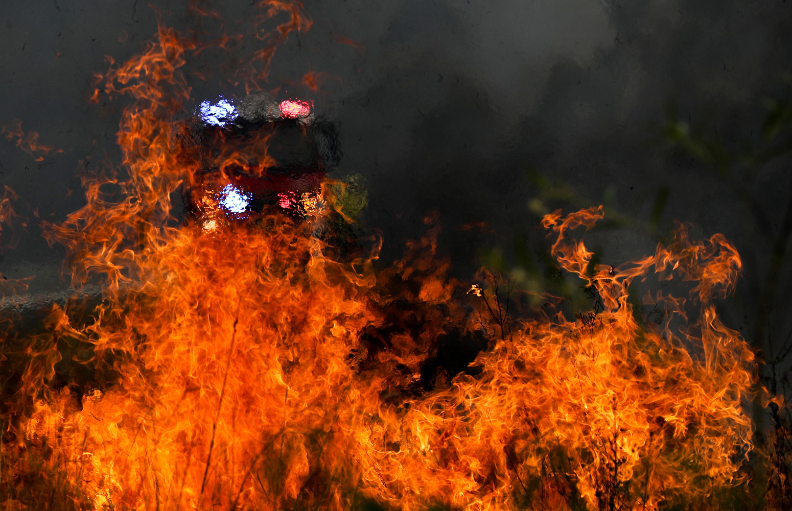 Firefighters battle the flames during bushfires near Taree, New South Wales, Australia (Nov. 11, 2019).
