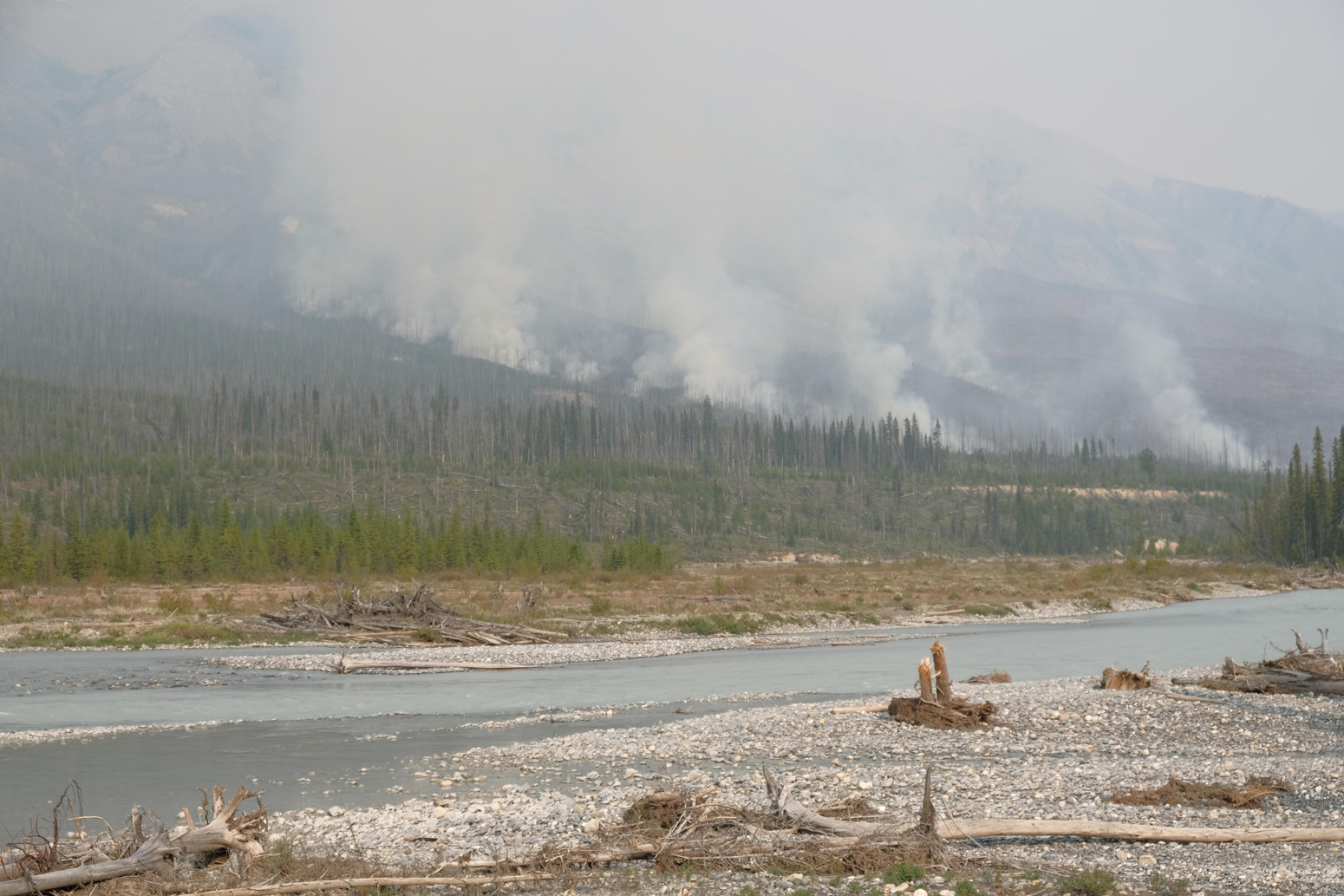 Forest fires burn in a river valley in western Canada during the summer of 2017.