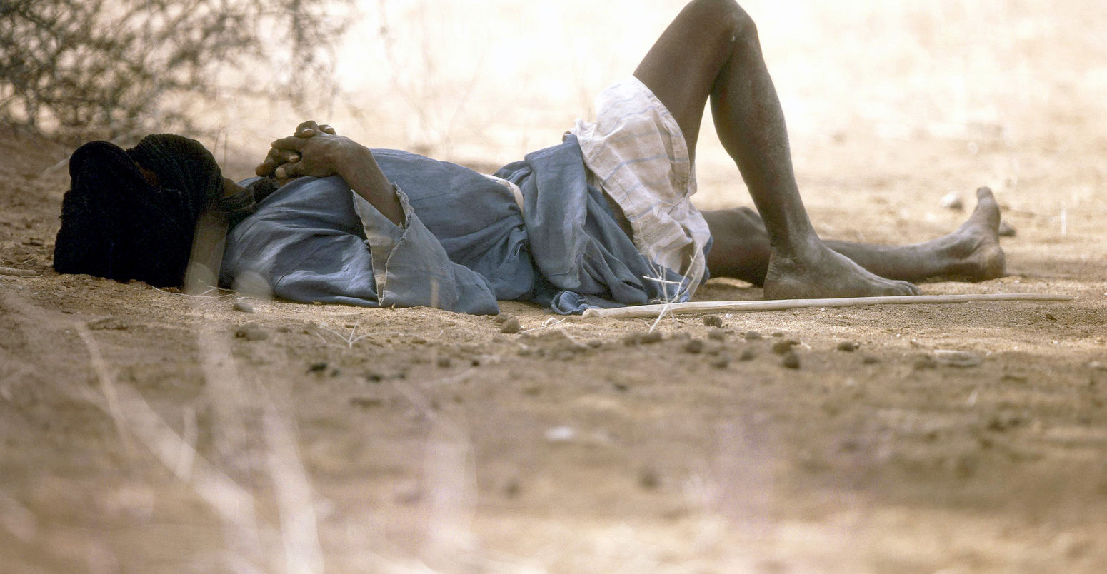 Mauritanian man shelting from the heat.