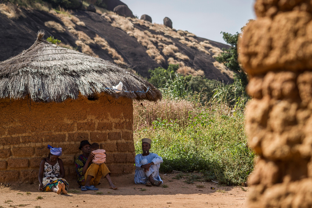 Fulani elders take a rest in the shadow on a hot day near Kaduna, Nigeria. Credit: Zsolt Repasy / Alamy Stock Photo.