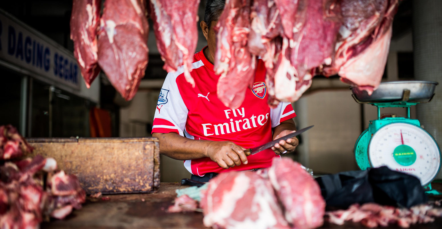 A butcher prepares cuts of meat in Kota Kinabalu, Malaysian Borneo.