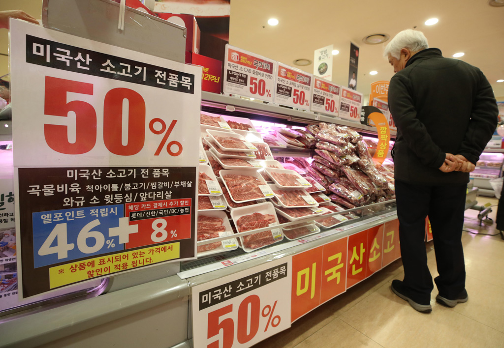 A man browses US beef on a shelf at a discount store in Seoul, South Korea.