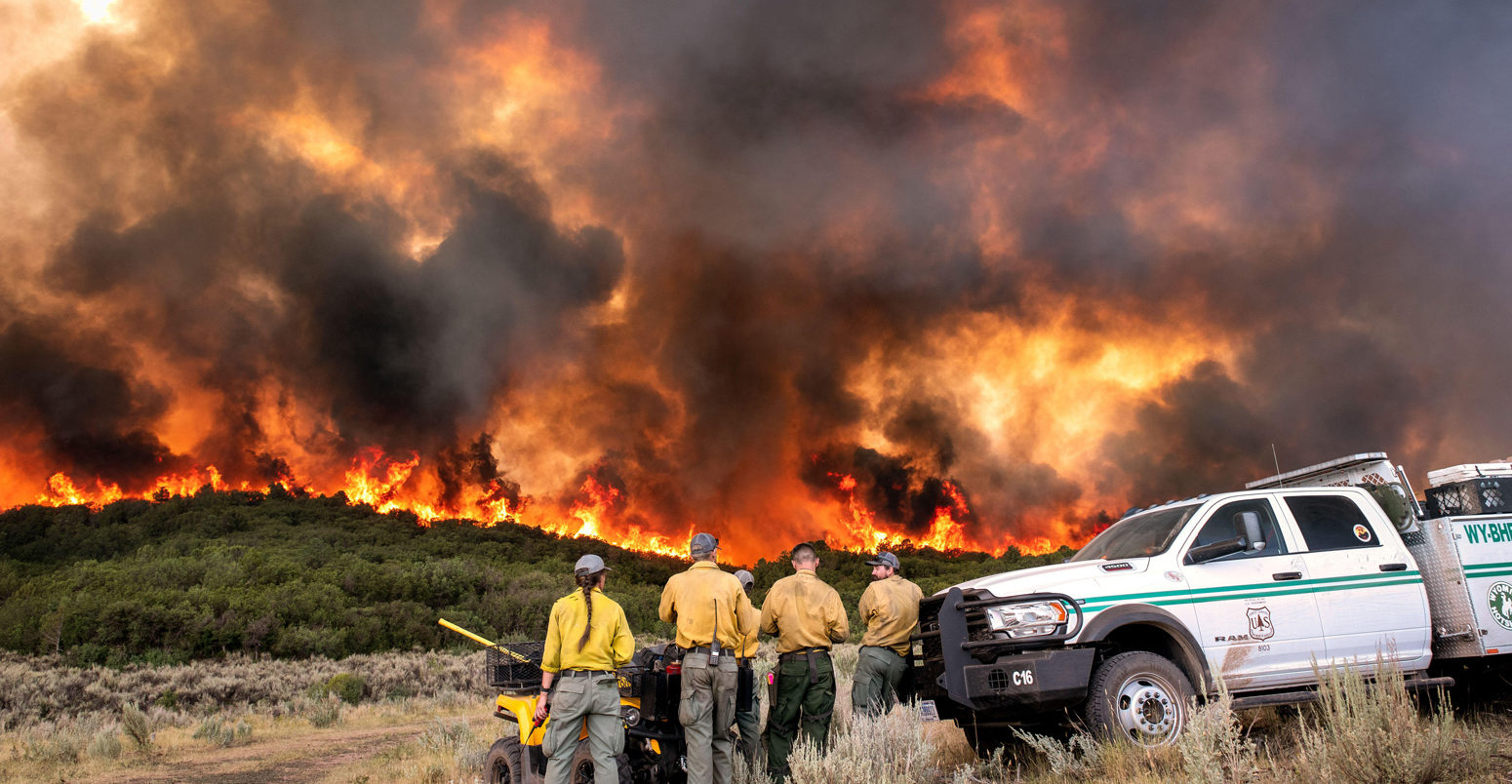 Firefighters watch the intense flames at the Pine Gulch Fire, Colorado.