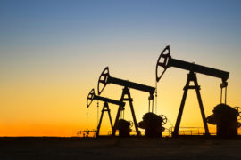 Silhouette of oil wells in desert at sunset, Texas, USA.