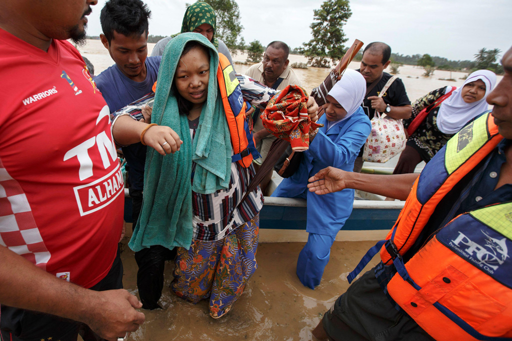 A-pregnant-woman-is-evacuated-from-her-home-by-rescue-workers-during-a-flood-in-Malaysia
