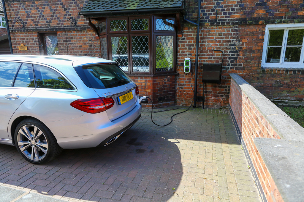A-Mercedes-C350-electric-hybrid-being-charged-by-a-home-charging-point
