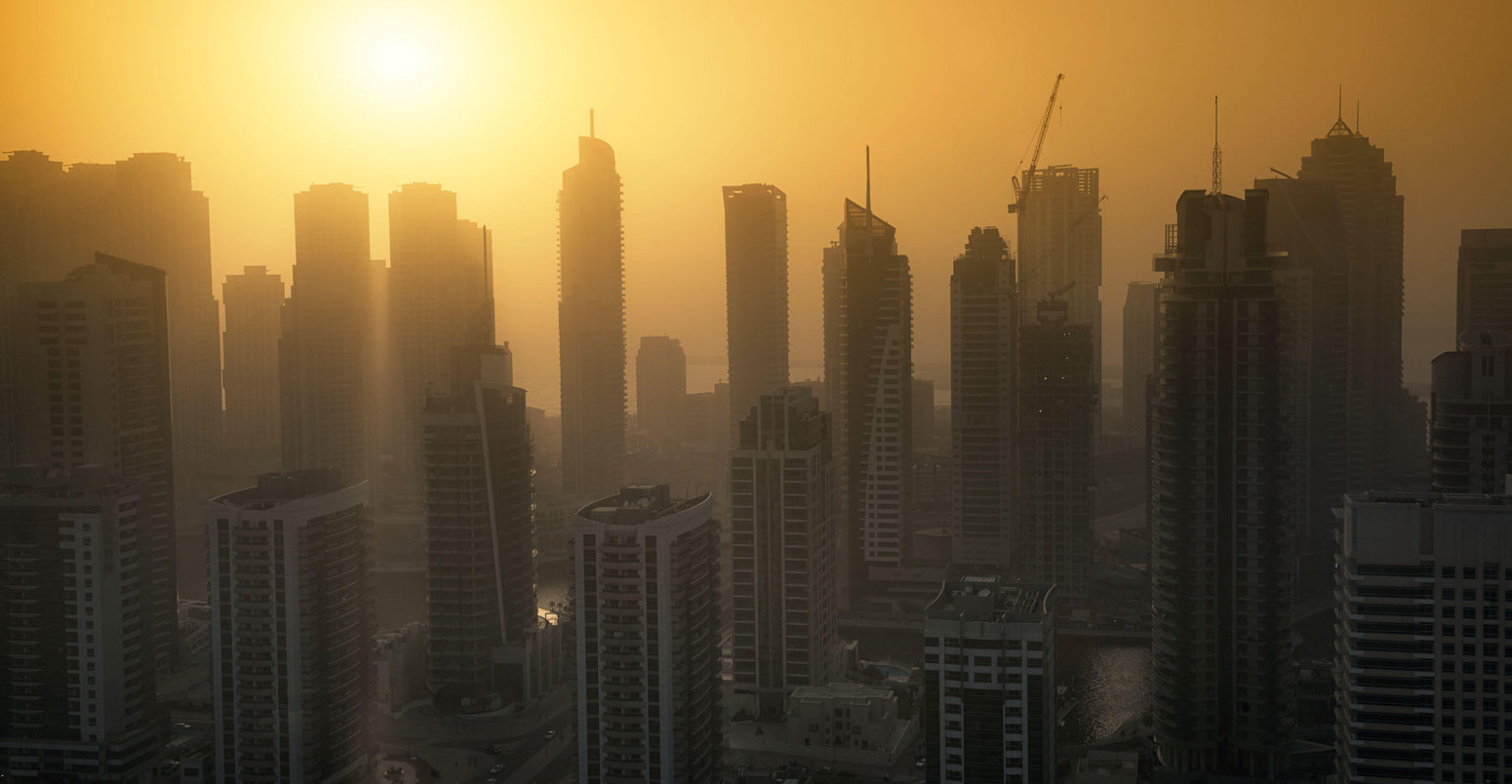 Dubai Marina skyscrapers at sunset with heat haze. May 2017. Andrew Deer / Alamy Stock Photo