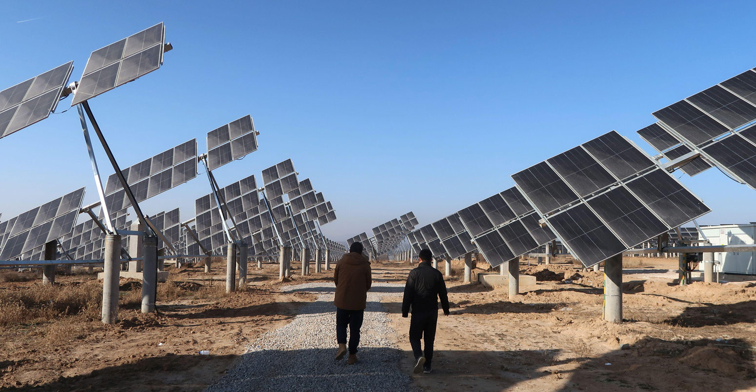 Workers walk at a solar power station in Tongchuan, Shaanxi province, China December 11, 2019. Picture taken December 11, 2019. Credit: REUTERS/Sean Yong