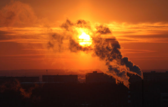 Red-sun-at-sunset-shrouded-in-smoke-from-plant-chimneys-in-Russia