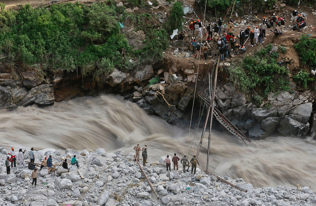 2013年，在喜马拉雅山的乌塔拉汗省戈文加特的救援行动中，士兵们试图修复阿兰克南达河上的一座临时人行桥，该桥被摧毁