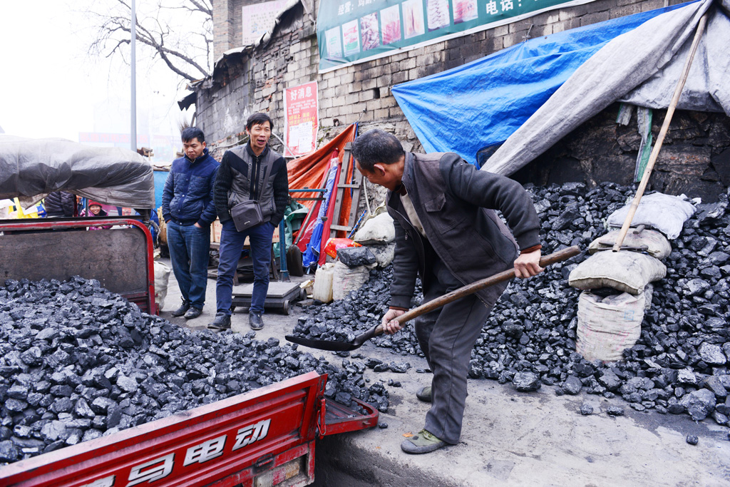A-Chinese-man-shoveling-coal-into-a-pickup-truck