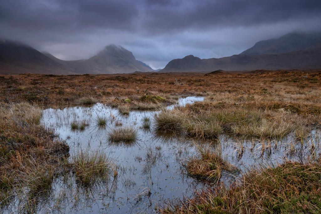 Peat bogs and moorland backed by the Cuillin Hills on Isle of Skye.