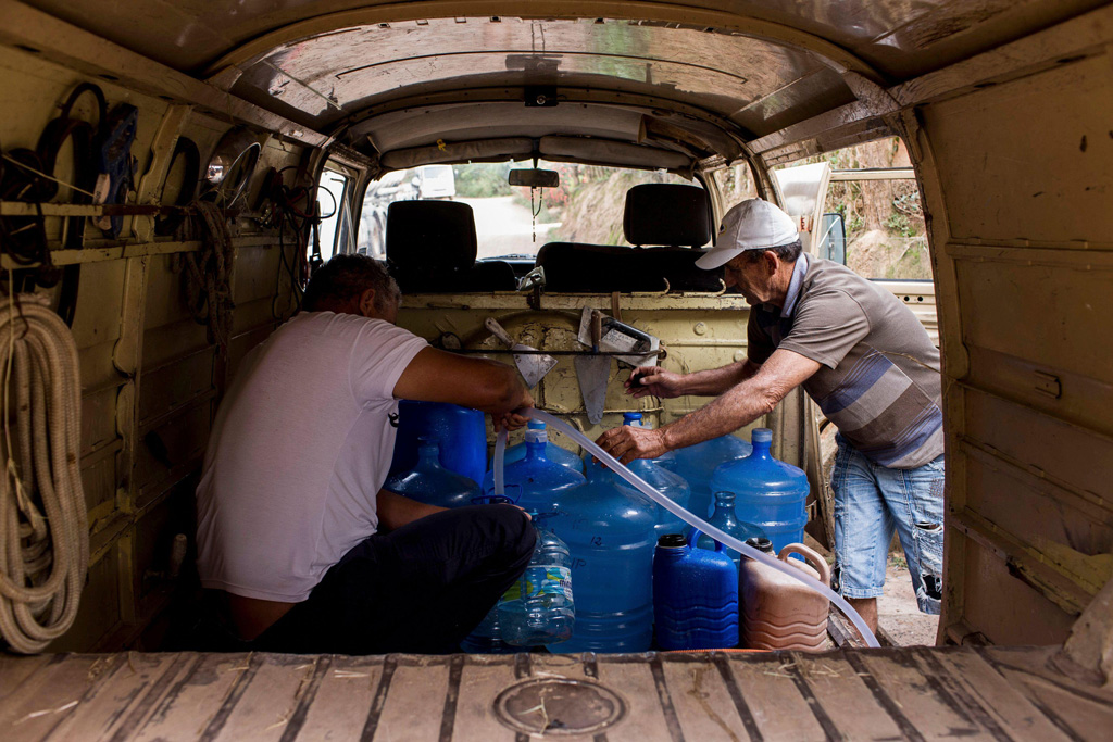 Residents of Sao Paulo receive water due to rationing in their homes during a record drought
