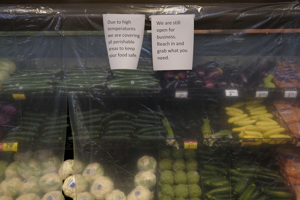 Perishable items are covered with a layer of plastic to keep in the cool air at a Fred Meyer grocery store in Portland