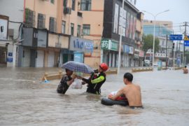 Firefighters help citizens with their vehicles and safety as Typhoon In-fa brings heavy rains and flooding in Ningbo City_2GA6GHR