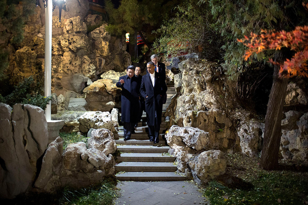 Barack Obama and Xi Jinping walk to a private tea at Zhong Nan Hai in Beijing, China