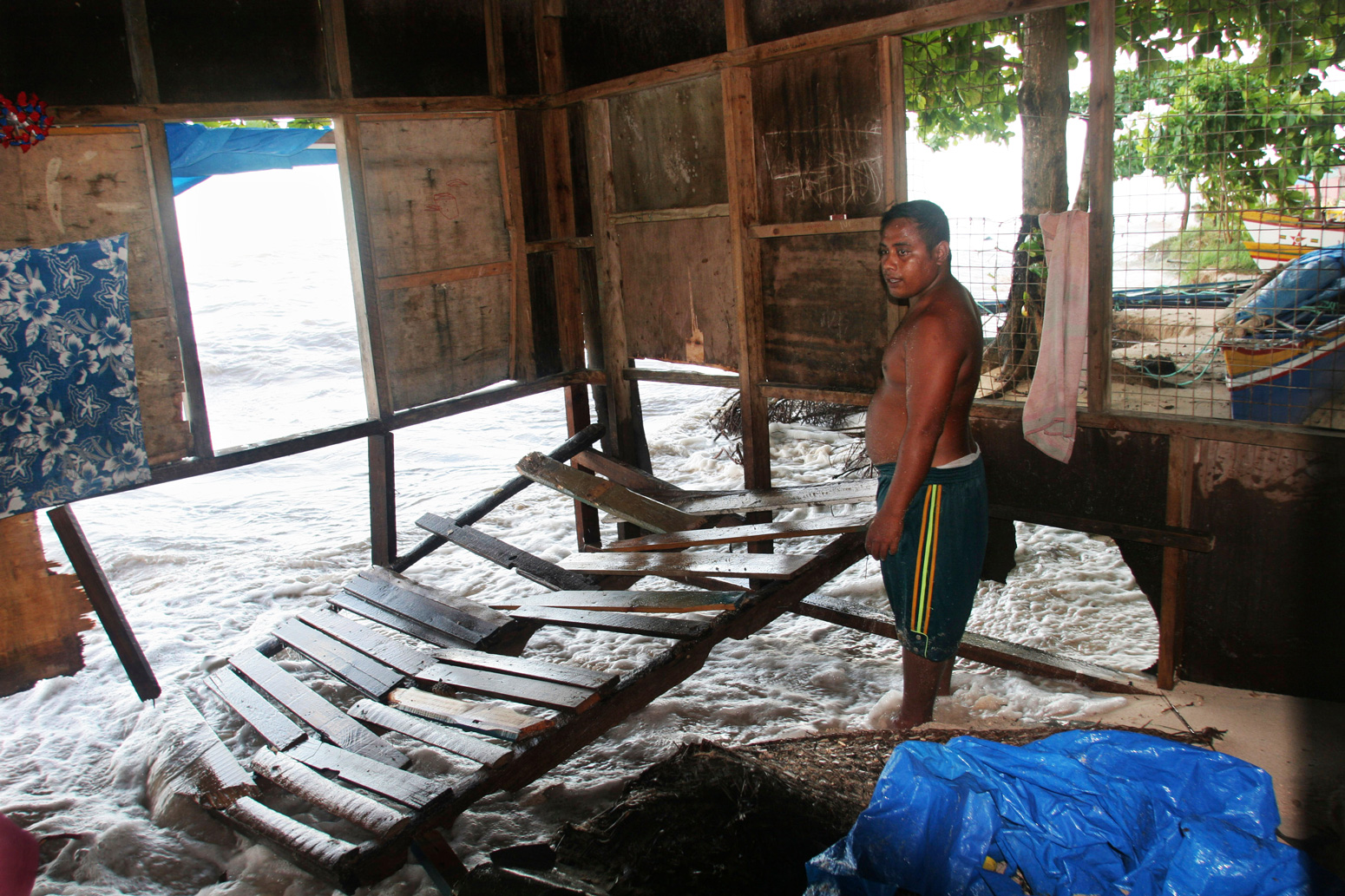 Flood damage a home on the island of Kiribati in the Pacific Ocean