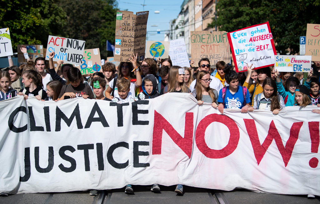 People in a demonstration in Munich with a Climate Justice Now banner